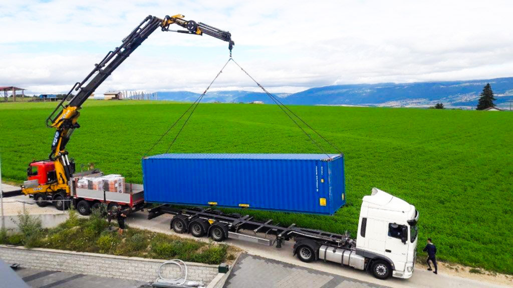 Shipping container being delivered for hire