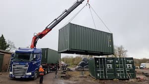 Taking a container of a HIAB lorry at a farm