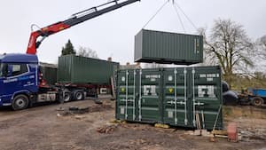 Shipping containers being unloaded with a crane