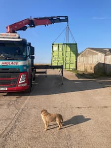 Used shipping container being delivered to a farm