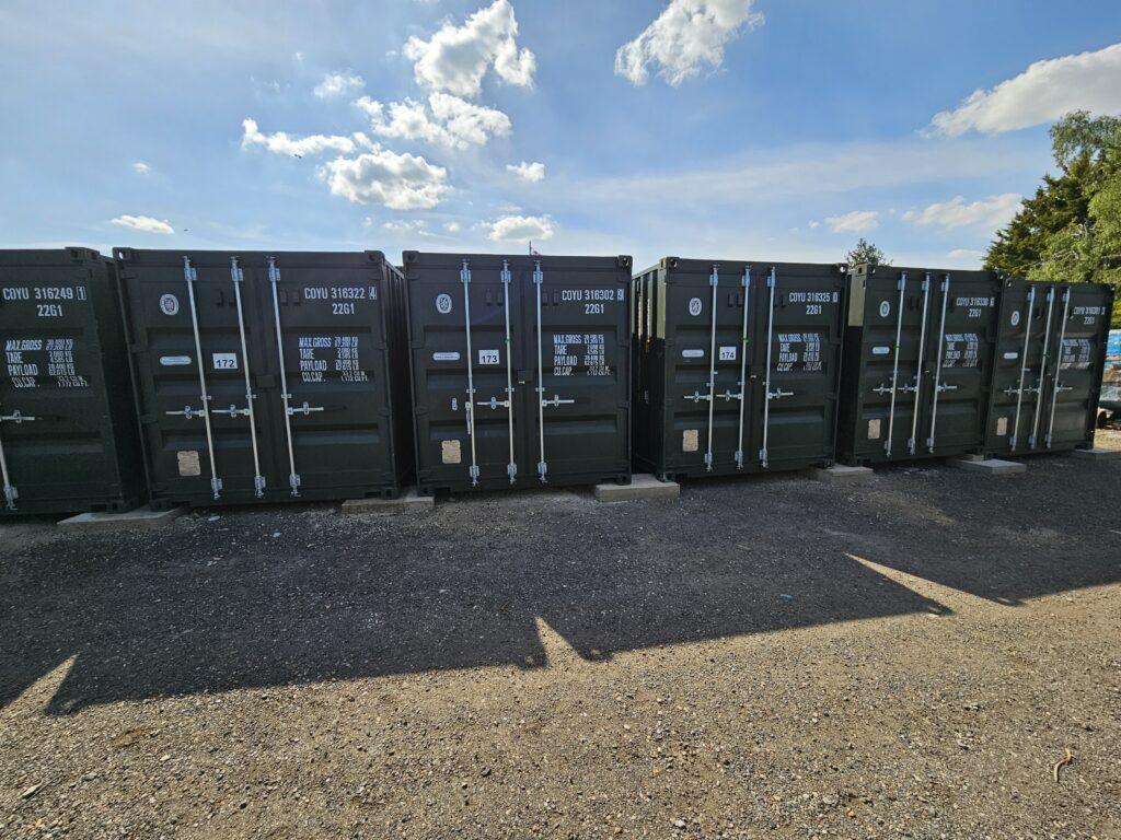 Several 20ft green containers at a self storage site