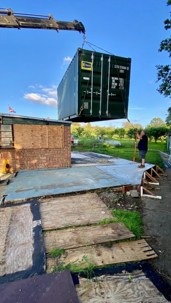 Shipping container being delivered