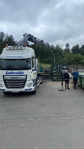 A HIAB lorry unloading a insulted and plywood container