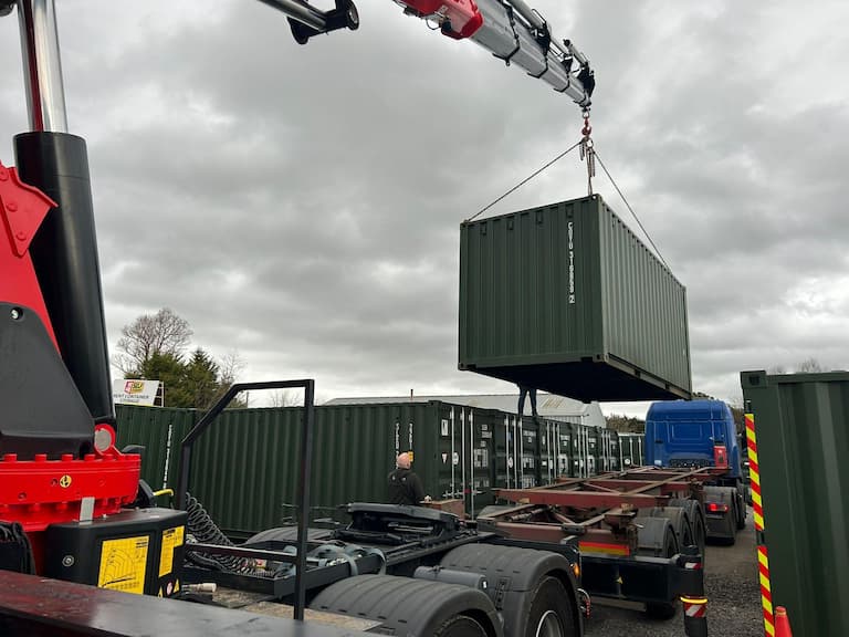 Shipping container being delivered