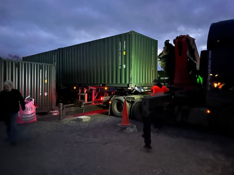 Shipping container being delivered in the dark