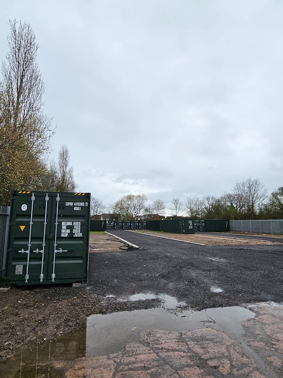 Shipping container at dark green at a self storage site